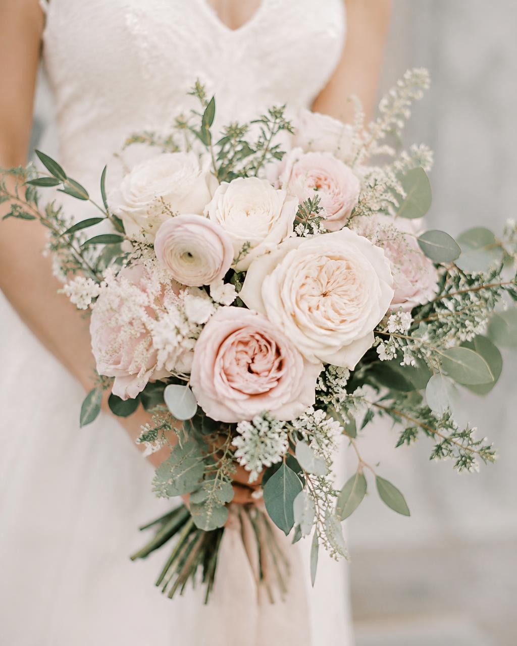 Bridal bouquet of ivory garden roses and blush ranunculus